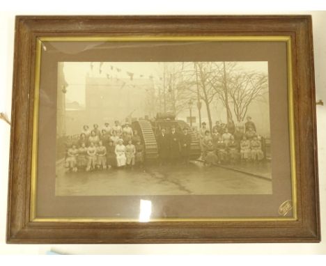 An early 20thC black and white photograph, depicting a First World War tank, various figures, female ammunition workers etc.,