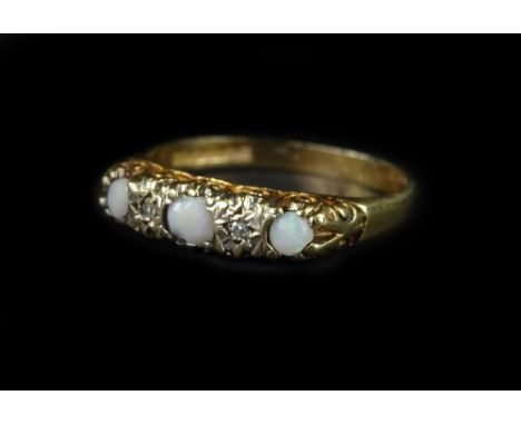 A 9ct gold gypsy ring, set with imitation opal and tiny white stones, in scroll design ring head, ring size O, 2g all in.