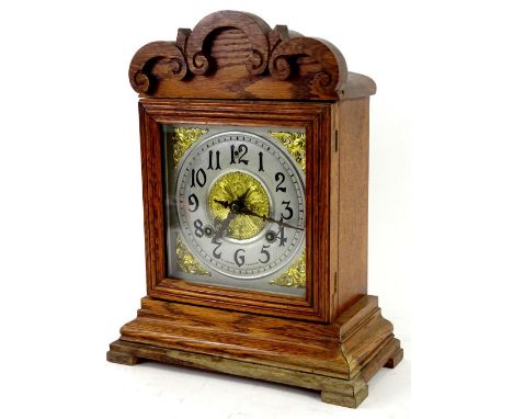 A German mantel clock in oak case, the square dial with Arabic numerals, signed RL Cozens Taunton, 36cm H.Provenance: This ti