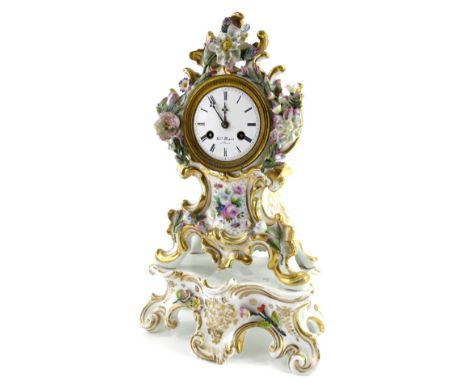 A 19thC French porcelain mantel clock, the case painted with flowers and with flower encrusted decoration, within rococo scro