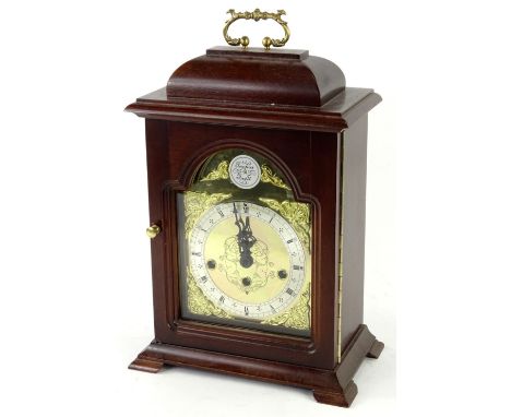 A German mahogany mantel clock in George III style, the arched dial inscribed Tempus Fugit above stylised engraving type deco