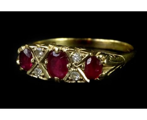 A 9ct gold dress ring, set with garnet and imitation diamonds, in gypsy style, with claw settings, and scroll design borders,