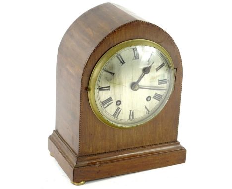An Edwardian mahogany and chequer banded lancet shaped mantel clock, the silvered dial with Roman numerals, 26cm H.Provenance