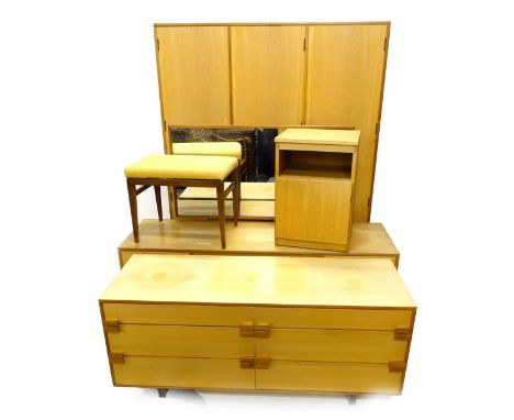 A 1970's/80's retro teak part bedroom suite, comprising six drawer low chest of drawers, dressing table, stool, wardrobe and 