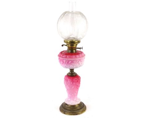 A Victorian pink opaque glass oil lamp, the Art Nouveau style frosted shade decorated with stylised fuscia leaves etc., the r