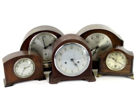 A collection of five mantel clocks and timepieces, to include a brown Bakelite cased piece, a presentation clock engraved To 