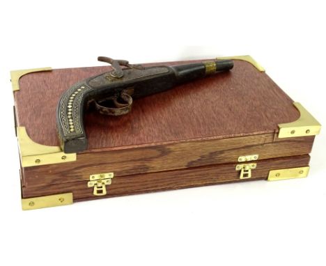 An Eastern hardwood pistol, with silver coloured metal and mother of pearl inlay, 34cm L. in an associated travelling case wi