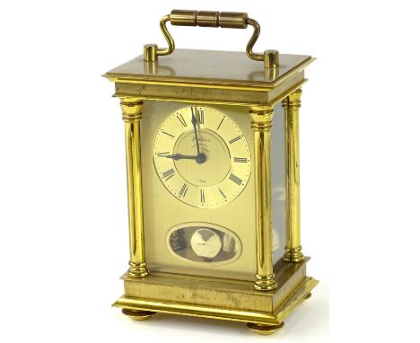 A Bentina brass carriage clock, with gilt dial, decorated with Roman Numerals, aperture for pendulum etc., 19cm H.