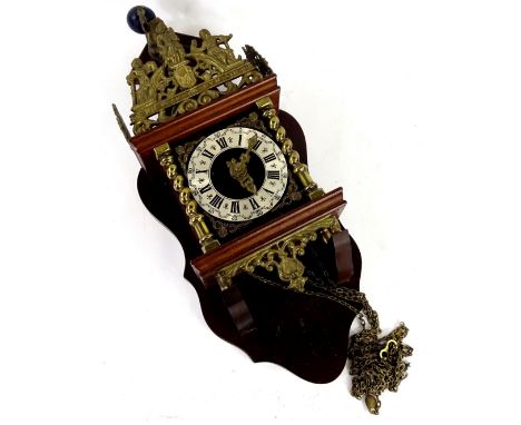 A Continental mahogany and brass wall clock, the raised top cast with a figure of Atlas, surrounded by various other Gods or 
