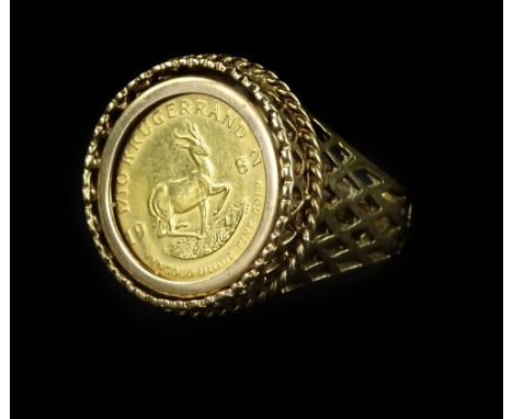 A coin ring, set with 1/10oz Krugerrand, in rope twist border, with pierced design band, yellow metal, unmarked, ring size R½