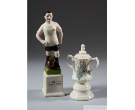 Two ceramic football souvenirs,
the first a miniature replica of the F.A. Cup trophy by One and All, decorated with heather a