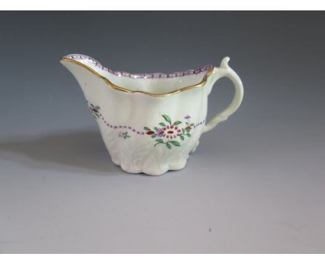 A First Period Worcester Cream Boat with relief moulded foliate and floral enamel decoration, c. 1765, 1 cm lip to handle, un