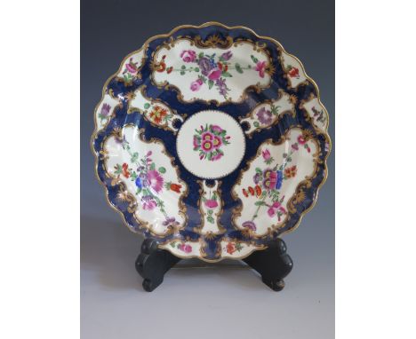 A Doctor Wall Period Lobed Shallow Bowl with blue scale and enamel floral decoration and gilt highlights, c. 1770, 21 cm