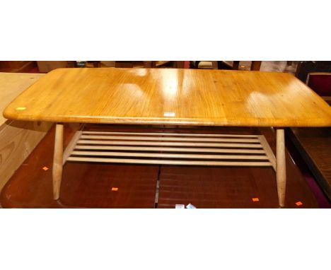 An Ercol light elm low coffee table having a laddered under tier, length 105cm