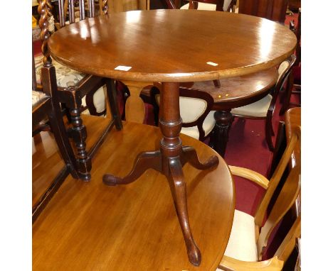 An early 19th century mahogany circular tilt top pedestal tripod table on hipped supports, dia. 74cmSome light marks to top o