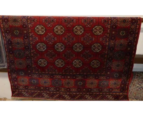 A Persian woollen red ground Bokhara rug, 185 x 139cmSome light fading all over, otherwise no faults