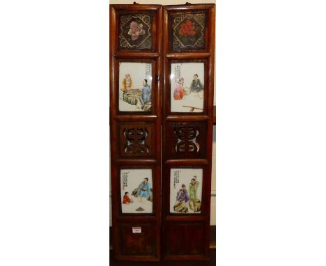 A pair of Chinese softwood panels depicting four enamel decorated porcelain plaques, late 20th century, each 93 x 18cm 