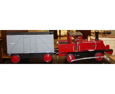 A scratch built and painted model traction engine titled "Brenda", with single goods wagon