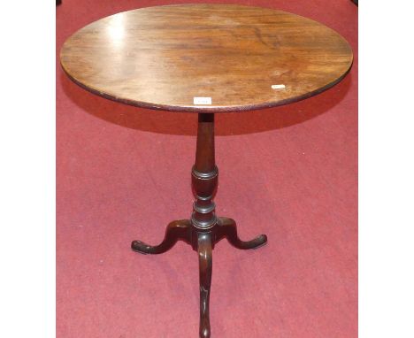 An early 19th century mahogany oval tilt top pedestal tripod occasional table raised on hipped supports, width 61cmSome light