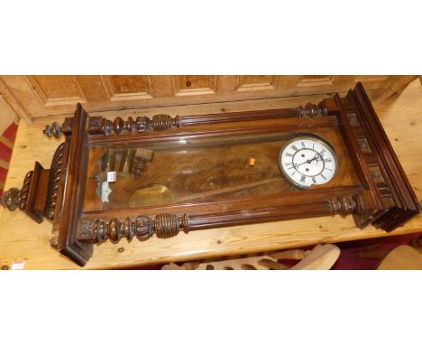 A circa 1900 Vienna walnut regulator clock, with typical glazed trunk door, white enamel dial, twin winding holes for an eigh