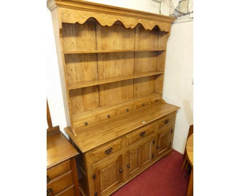 A contemporary joined light elm Welsh dresser, having three-tier open plate rack, fitted with five short lower drawers over b