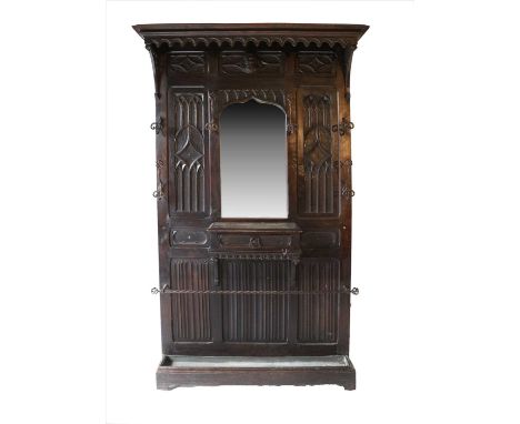 A Victorian Oak Hall Stand, 3rd quarter 19th century, with an arcaded canopy top above a central bevelled glass mirror plate 