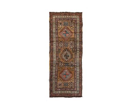 North West Persian Kurdish Runner, circa 1920The camel field with three latch hook medallions surrounded by similar medallion