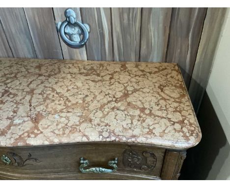A 19th Century French Walnut Commode, with four deep drawers below an original pink marble serpentine top, with original bras