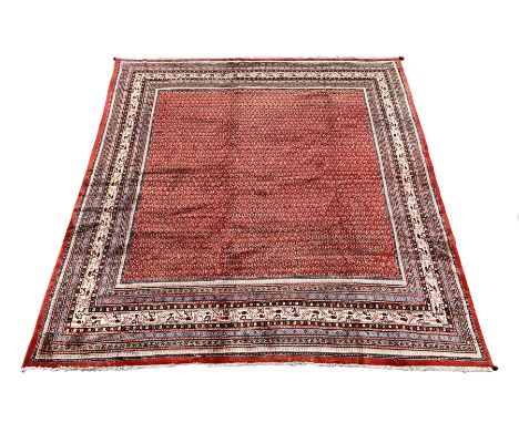 Large Persian Araak rug carpet, the red field decorated with repeating boteh motifs, multiple band border, 364cm x 304cm  - C