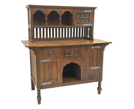 Arts and Crafts period oak sideboard, raised triple shaped arch top fitted with cupboard, rectangular top over three drawers 