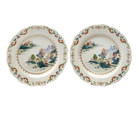 Pair of Chinese Export Famille Rose plates, Qianlong period, enamelled in polychrome with flowers, rockwork and pagoda to the