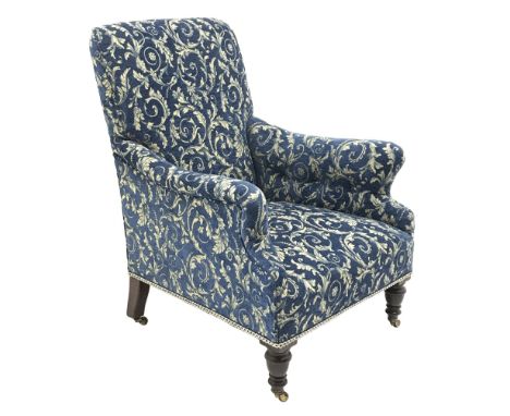  Victorian mahogany and beech framed armchair, turned front supports on brass and ceramic castors, upholstered in blue classi