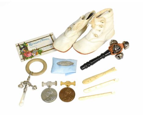 Circa 1900 and Later Baby Items comprising a pair of white leather bootees with four button fastening and tassle trimpatent s