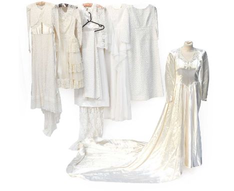 Mid 20th Century Wedding Dresses, comprising a circa 1940s cream satin long sleeved dress with sweetheart neckline trimmed wi