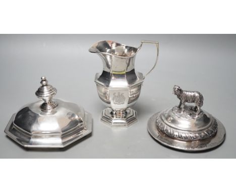 A 20th century silver cream jug by Mappin &amp; Webb(date letter rubbed), height 13.9cm and two Victorian trophy cup covers, 