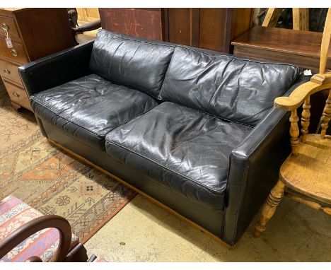 A black leather upholstered two seater sofa bed, length 172cm