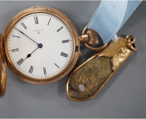 An early 20th century engraved 9ct gold hunter fob watch, with Roman dial, gross 36.7 grams, on a blue sash with yellow metal