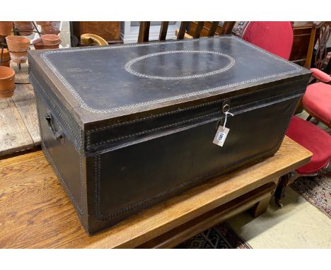 An early 19th century brass mounted studded black leather trunk, length 92cm, depth 46cm, height 42cm