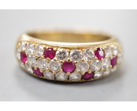A modern yellow metal, ruby and diamond cluster set half hoop ring, size L/M, gross weight 4.5 grams.