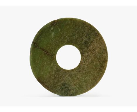 A Chinese dark green jade disc, Bi Warring States The opaque dark green stone with dark brown and cloudy inclusions of even t