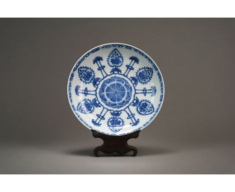 A Chinese blue and white lotus dish Kangxi Of plain round form, decorated with a central lotus medallion surrounded by a repe