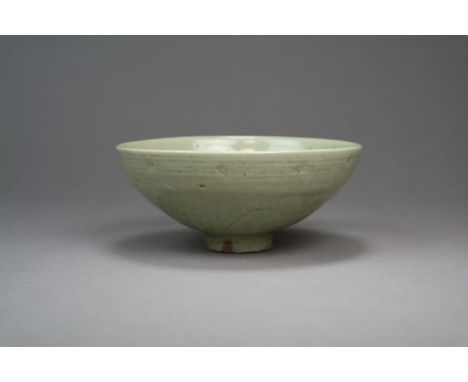 A Chinese longquan celadon bowl Ming Dynasty Of plain rounded form, incised inside and out with stylised leaf forms, all unde