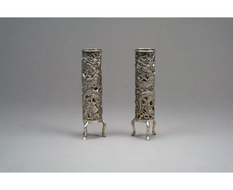A pair of Chinese silver pierced bud vases by Wang Hing Canton circa 1900 Of cylindrical form and raised on three scroll feet