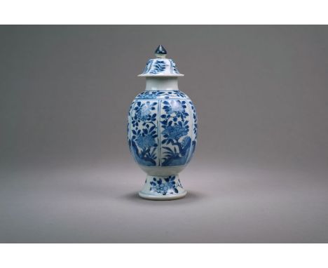 A Chinese blue and white tea caddy and cover Kangxi Of ovoid form, the domed cover with cone finial, decorated with panels of