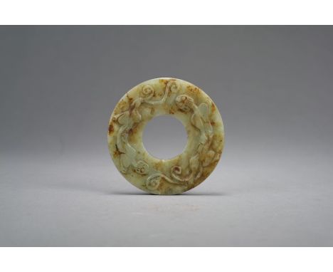 A Chinese pale green jade 'chilong' disc, Bi Qing Dynasty The pale green stone with russet staining and cloudy inclusions, wo