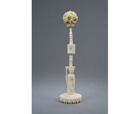 A Chinese ivory puzzle ball on stand Late 19th Century The ball carved with dragons amid clouds, the stand modelled as a figu