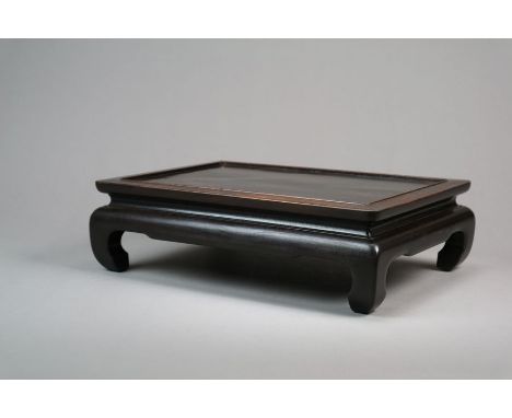 A Chinese rosewood display stand Qing Dynasty Of rectangular form, the moulded top above a shaped apron and raised on short s