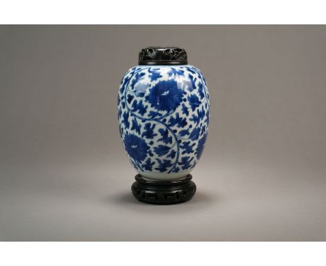 A Chinese blue and white vase Kangxi Of ovoid form and decorated with lotus flowers and scrolling foloiage, replacement carve