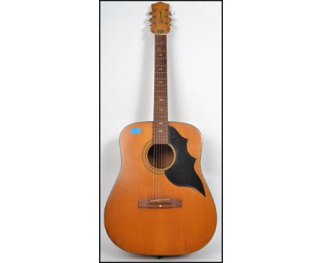A vintage 20th century Futurama jumbo six string acoustic guitar having a shaped hollow body with mother of pearl fret marker