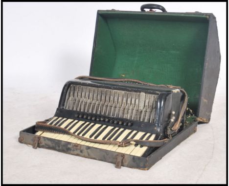 Musical Instruments. A cased vintage early 20th century accordion having original case and in a black finish to the instrumen